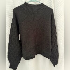 Elegant Black Turtleneck Sweater with Textured Sleeves